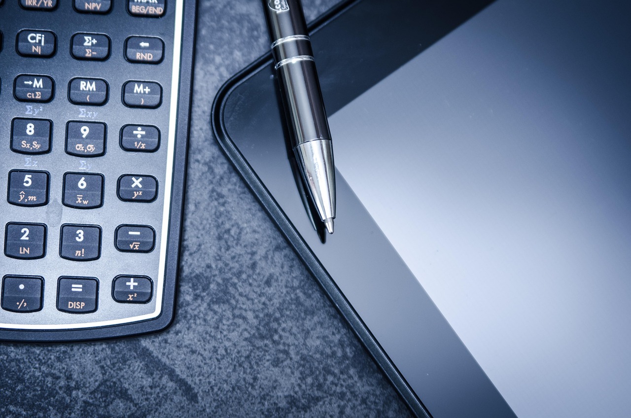 Tablet, calculator, business — Adaptiv - Your Trusted Partner for Secure and Compliant Travel Agency Payment Processing